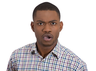 Closeup portrait of angry young upset man  isolated on white background. Negative human emotions facial expression feelings attitude