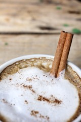 hot cappuccino with spices cinnamon sticks and star anise.