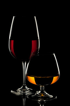 Wine Glass and Whiskey Glass on black background