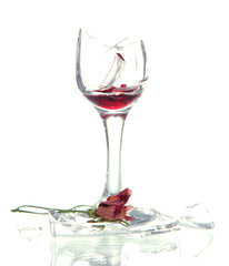 Broken wineglass and dry flower isolated on white