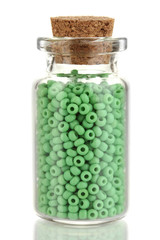 Little bottle full with colorful beads isolated on white