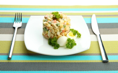 Russian traditional salad Olivier, on color napkin background