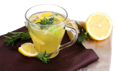 Cup of tea with ginger on napkin on wooden table