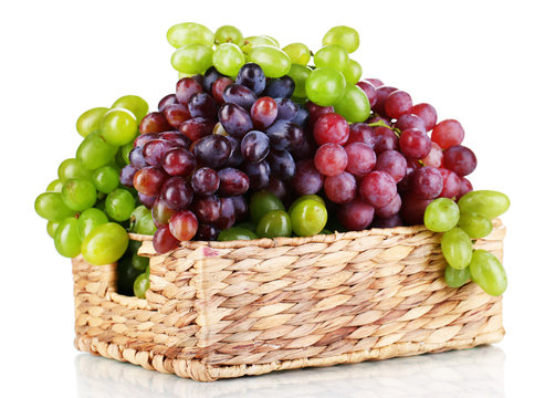 Ripe green and purple grapes in basket isolated on white