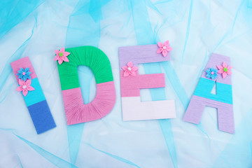 Word Idea created with brightly colored knitting yard