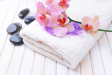 Still life with beautiful blooming orchid flower, towel and