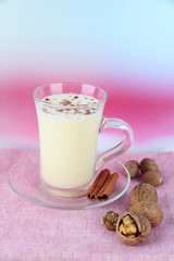 Cup of eggnog with cinnamon and nuts