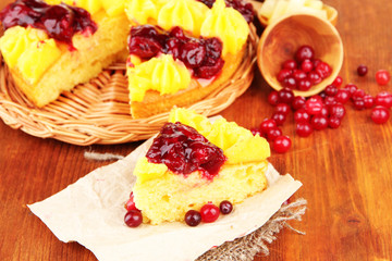 Tasty fruity homemade pie with berries, on brown wooden table