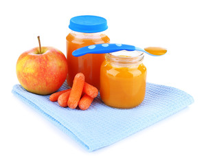 Baby food with carrot and apple in glass jars, isolated on