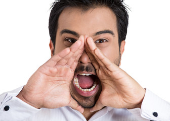 Angry, mad young man screaming at someone