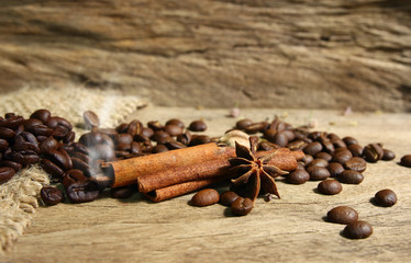 Roasted coffee beans  and spices on grunge wooden board  backgro