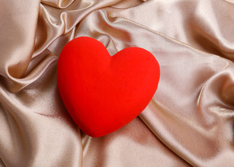 Decorative red heart, on color fabric background