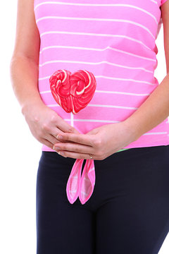 Pregnant woman holding red lollipop close up
