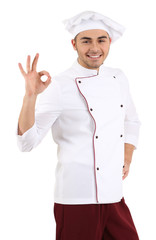Professional chef in white uniform and hat, isolated on white