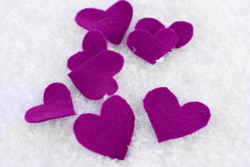 Fototapeta premium Little felt hearts on snowy background