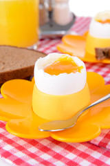 Boiled eggs in egg cups on table close-up