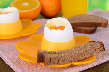 Boiled eggs in egg cups on table close-up