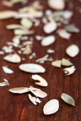 Peeled pumpkin seeds on wooden background