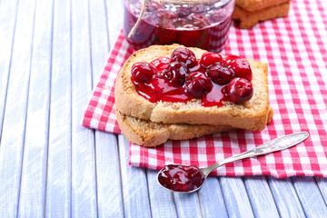Delicious toast with jam on table close-up