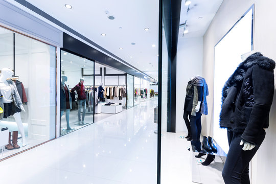 Boutique display window with mannequins in fashionable dresses