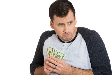 Greedy young man holding dollar bills, money
