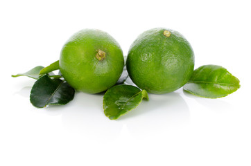 Limes with leaves isolated on white background