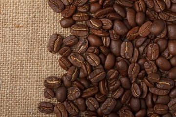 Coffee beans on sack cloth background
