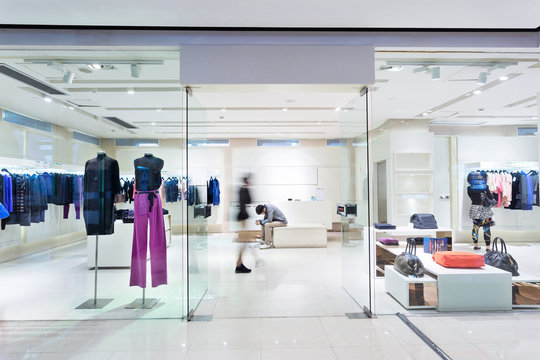 Boutique display window with mannequins in fashionable dresses