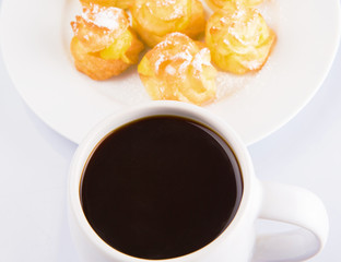 Homemade cream puff and a mug of coffee