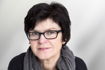 Fototapeta premium Portrait of a woman with glasses in middle age