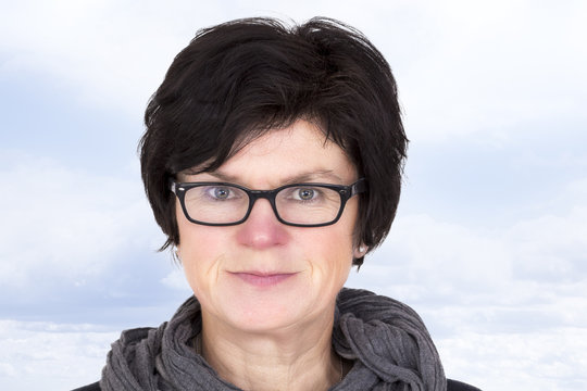 Portrait of a woman with glasses in middle age