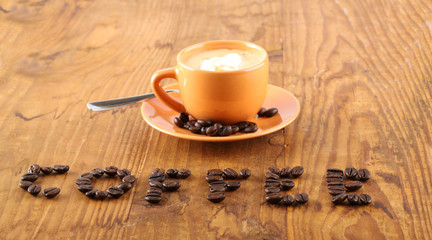 Cup of coffee with coffee beans