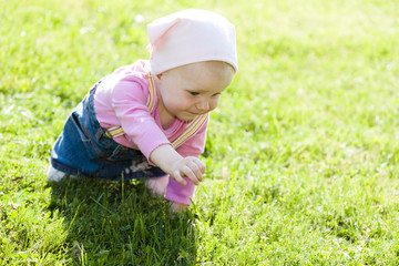 toddler girl crawling on lawn