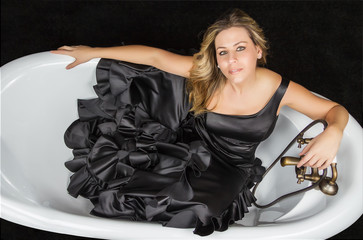 Fototapeta na wymiar Girl with spanish flamenco dress in a bathtub