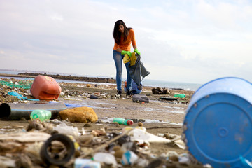 Strong young woman cleaning and volunteering