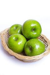 Basket of green apples .