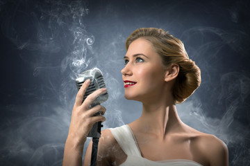 beautiful blonde woman singer with a microphone