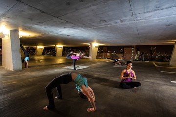 Young Woman holding yoga poses in a public space