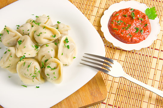 dumplings on a plate and tomato sauce