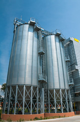 Silver Grain Silos with blue sky in background