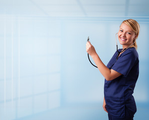 Pretty nurse in hospital listening to empty copy space with sthe