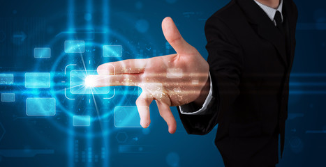 Businessman pressing high tech type of modern buttons