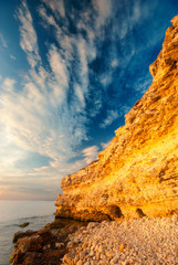Coastal cliffs and the beach at sunset