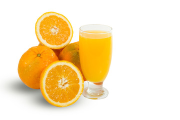 Glass of fresh orange juice with sliced oranges on white backgro