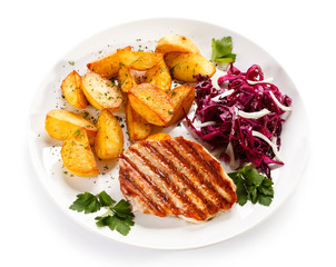 Grilled steak, baked potatoes and vegetables