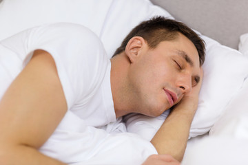 handsome man sleeping in bed