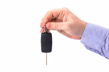 Hand with car key isolated on white background