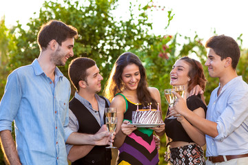 Group of teenage friends toasting a birthday girl.