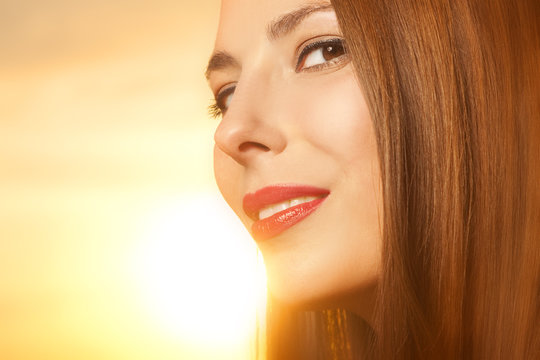 Beautiful, happy young woman in sunlight