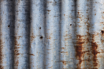 Rusty old corrugated iron fence close up